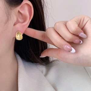 Irregular textured oval gold stud earrings with concave geometric design for women