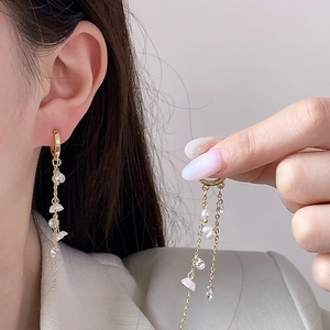 Vintage style gold tassel earrings with irregular pearls and crystals on elegant model