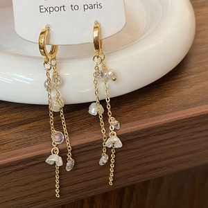 Detailed close-up of vintage flower tassel earrings with pearls and gold chains