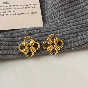 Polished gold four-leaf flower stud earrings with elegant woven metal knot design
