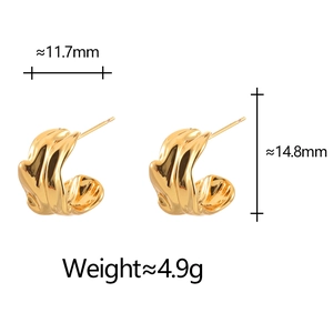 Detailed view showing 11.7mm wide gold-plated C-shaped earrings with wavy texture