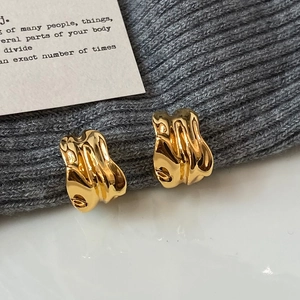 Minimalist irregular geometric C-shaped gold-plated earrings with molten lava texture finish