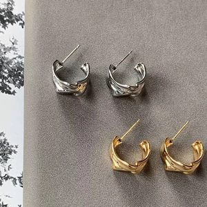 Irregular lava texture C-shape stud earrings in gold and silver finish for women