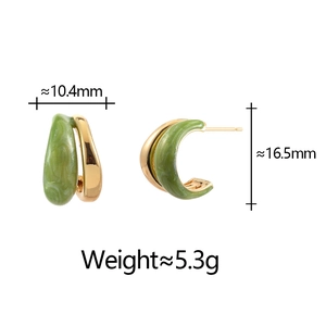 Detail shot of C-shaped gold earrings with green marble enamel and size measurements