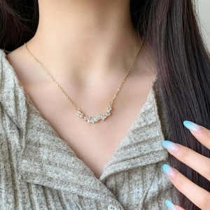 Elegant gold wisteria necklace with zircon crystals on a model for a chic aesthetic