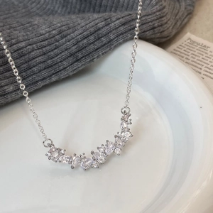 Elegant silver necklace with wisteria-inspired zircon crystals on a white plate