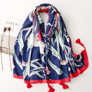 Floral print summer shawl in navy blue with red tassels and lightweight fabric finish