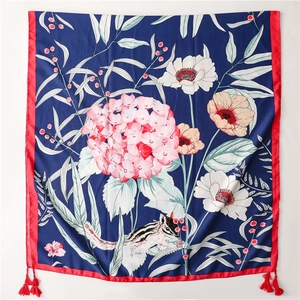 Detail of silk scarf with pink hydrangeas, squirrels, red borders and tassel corners
