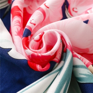 Macro shot of silk scarf showing pink floral prints and fine twill weaving texture
