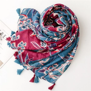 Soft cotton-linen scarf with red and blue floral print and fringe tassels for sun protection