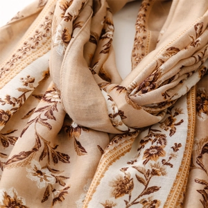 Detail of vintage floral print scarf with soft texture and refined fringe edges