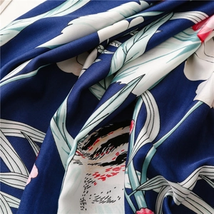 Macro shot of navy blue floral silk scarf with twill weave and elegant drape detail