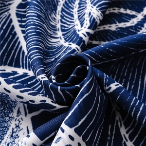 Close-up of navy blue floral silk scarf showing premium twill fabric texture and details