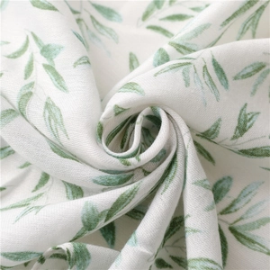 Close-up of green leaf pattern on breathable cotton linen fabric with soft texture