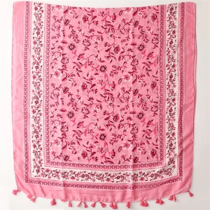 Macro view of floral pattern and fringe tassels on pink cotton-linen scarf