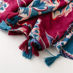 Macro shot of boho floral print scarf with soft texture and ethnic tassel fringe details