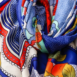 Macro detail of silk shawl showing bright ethnic patterns and fine twill weave texture