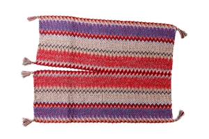 Close-up of colorful chevron knit pattern and fringe detail on ethnic travel poncho