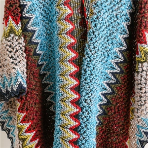 Close-up of bohemian chevron knit pattern with vibrant red, blue, and yellow yarns