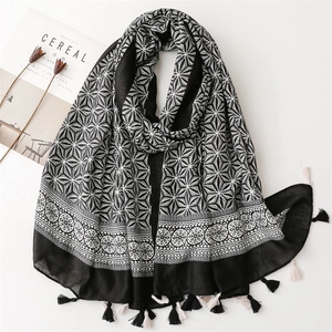 Detail of black and white geometric pattern scarf with elegant fringe and cotton feel
