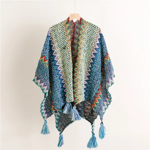 Detail of colorful zigzag knit pattern and blue tassels on Bohemian style travel shawl