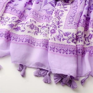 Close-up of lavender floral print scarf with soft texture and delicate tassel edges