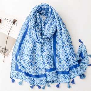Blue and white geometric pattern linen-feel scarf with blue tassels on white background