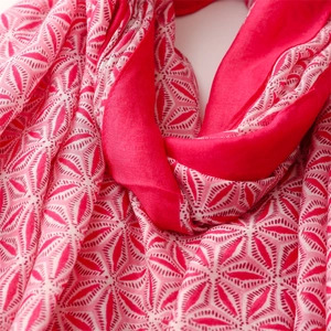 Detail shot of pink linen-touch silk scarf showing elegant geometric leaf patterns