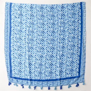Detail of blue geometric print cotton-linen scarf with elegant dual-tone tassels