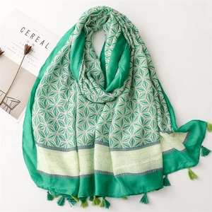 Lightweight cotton-linen scarf featuring green geometric patterns and soft tassels