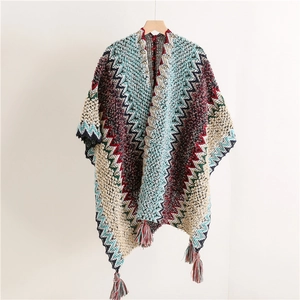 Detail of bohemian knit shawl featuring colorful zigzag patterns and tassel fringe