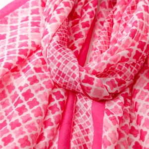 Detail of soft pink and white floral pattern on lightweight cotton-linen scarf fabric