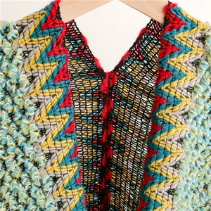 Detail of colorful chevron knit shawl with V-neck design and multi-color wave texture