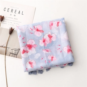 Detail of pink orchid print and soft fringe on light blue linen feel shawl scarf