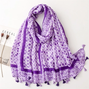 Detail of purple cotton linen scarf with clover patterns and delicate tassels