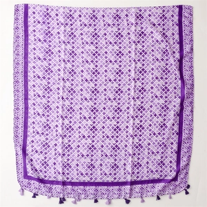 Detail of purple scarf featuring clover prints, mesh borders and delicate fringe accents