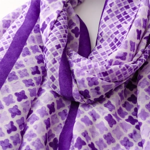 Macro detail of purple butterfly pattern scarf with elegant silky texture and drape