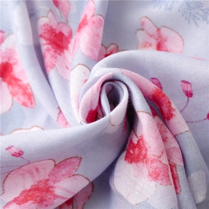 Macro shot of traditional floral pattern scarf showing soft cotton-linen texture and weaving