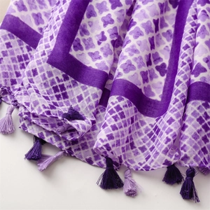 Detail of purple cotton linen scarf showing star patterns and soft bicolour tassels