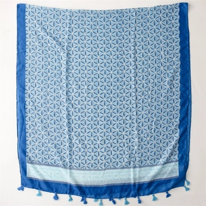 Detail of blue printed shawl showing soft geometric patterns and light blue tassel fringe