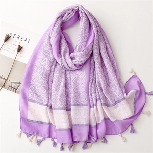 Detail of lavender floral scarf with cotton tassels and bohemian geometric print