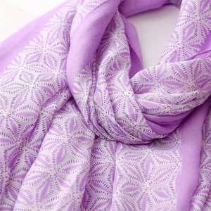 Detail of soft linen-feel scarf with purple geometric floral pattern and fine fringe