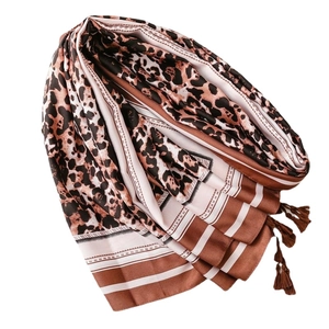Leopard print silk scarf shawl with striped borders and tassels on white background