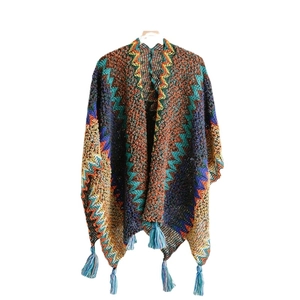 Ethnic knit shawl with colorful geometric patterns and blue tassels for travel wear