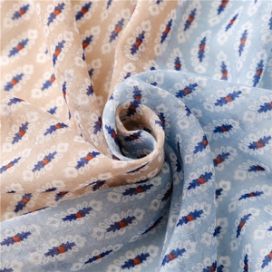 Close-up of bohemian scarf fabric showing soft geometric floral patterns and breathable texture
