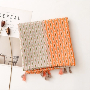 Flat lay of bohemian scarf with small floral geometric patterns and fringe tassel edge