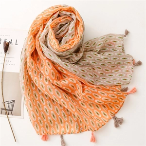 Bohemian floral scarf wrap with orange and beige patterns and decorative tassels