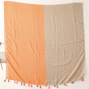 Detail of bohemian scarf with geometric patterns and dual-tone orange and grey fringes