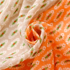 Close-up of soft bohemian floral voile fabric with vibrant geometric patterns