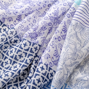 Detailed close-up of blue geometric patterns and floral print on soft cotton-linen scarf